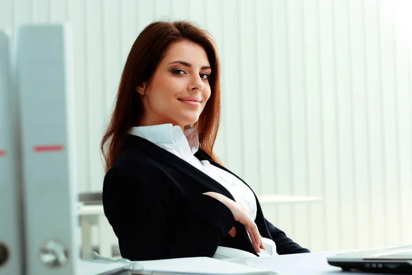 Empresária sentada à mesa no escritório — Fotografia de Stock