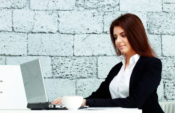 Businesswoman sitting at the table in office — Stock Photo, Image