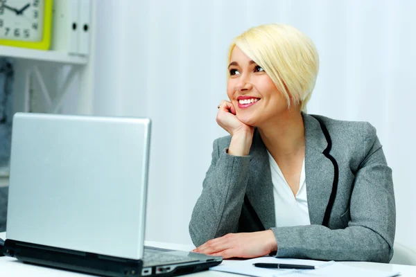 Empresária sentada à mesa com laptop — Fotografia de Stock