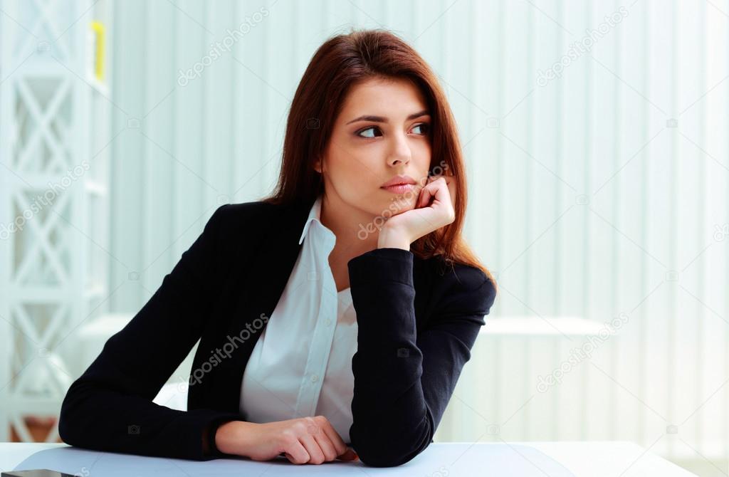 Businesswoman sitting at the table on her workplace