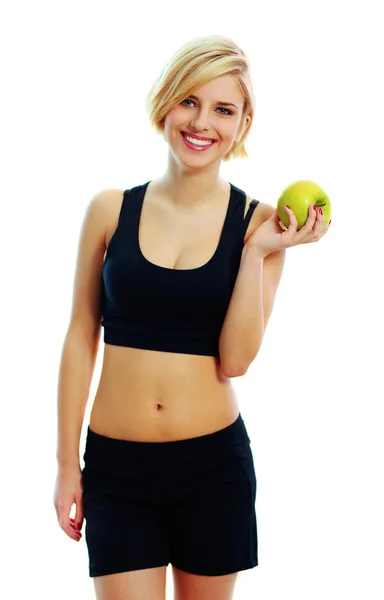 Fit woman holding green apple — Stock Photo, Image