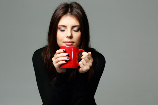Woman smelling the aroma of coffee