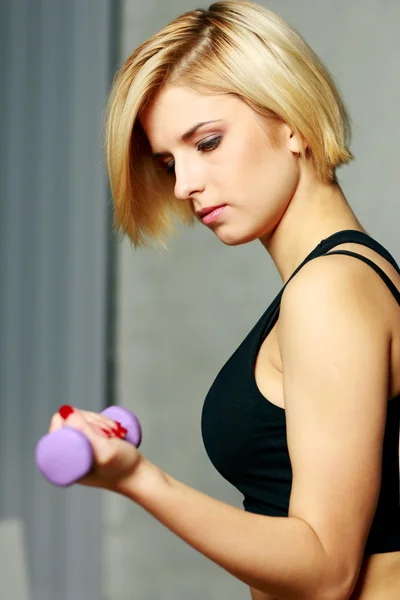 Woman doing workout with dumbbell — Stock Photo, Image