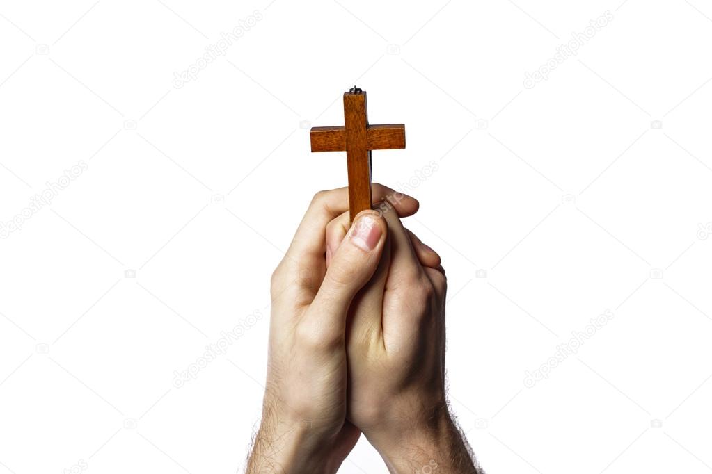 Male hands holding wooden cross