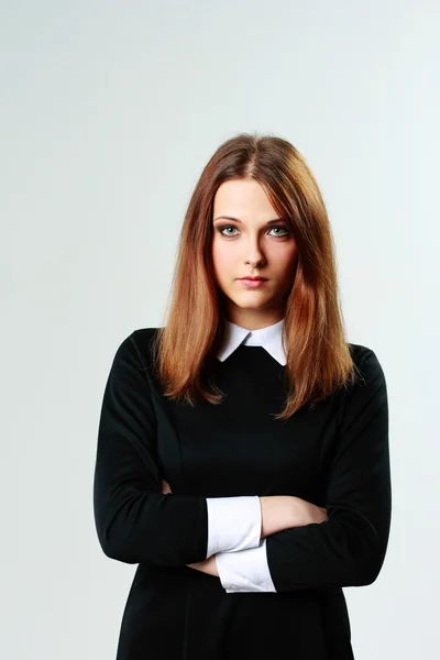 Woman standing with arms folded — Stock Photo, Image