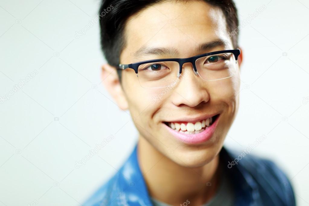 Young handsome asian man in glasses
