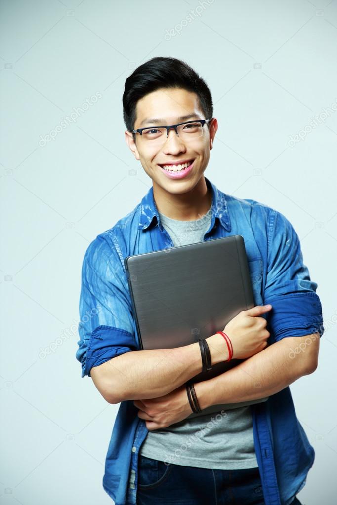 Young handsome asian man in glasses