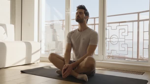 Concentrated Man Sitting Lotus Position Home — Stock Video