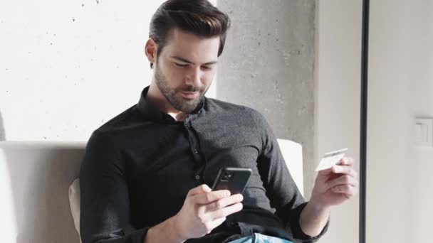 Smiling Businessman Looking Phone Bank Card His Hand Home — Stock Video