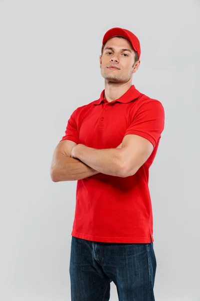 Young Delivery Man Wearing Uniform Posing Arms Crossed Isolated White — Stock Photo, Image