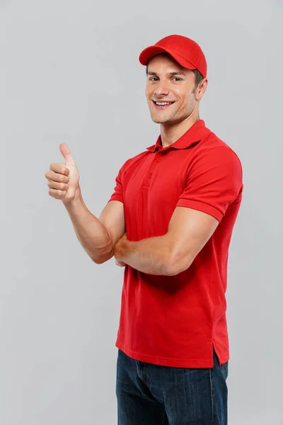 Young Delivery Man Wearing Uniform Smiling While Gesturing Thumb Isolated — Stock Photo, Image