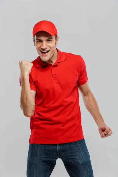 Young Delivery Man Wearing Uniform Screaming While Making Winner Gesture — Stock Photo, Image