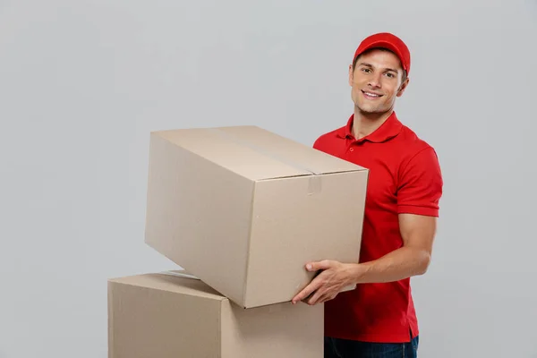 Young Delivery Man Hat Smiling While Posing Cardboard Boxes Isolated — Stock Photo, Image