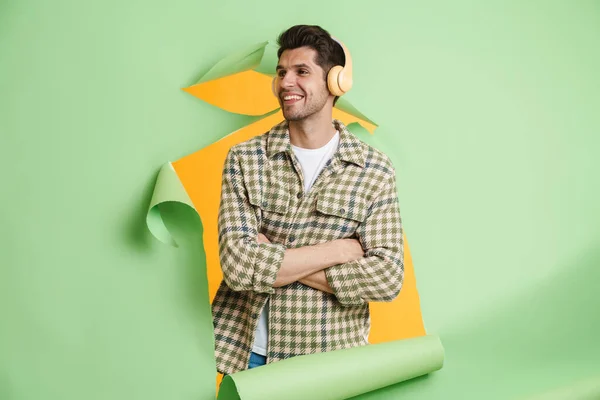 Smiling Young Casual White Man Looking Out Torn Paper Hole — ストック写真