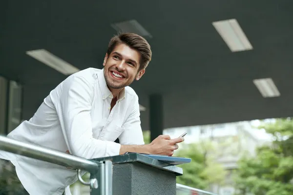 Pleased European Businessman Holding Mobile Phone Documents Young Man Standing Royalty Free Stock Photos