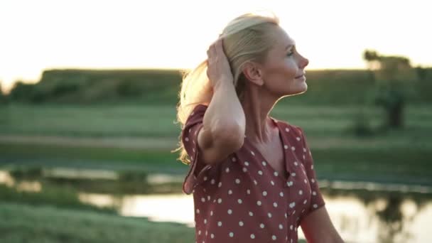 Счастливая Женщина Исправляет Прическу Ходит Полю Реки — стоковое видео
