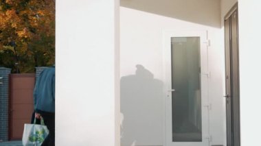 Gülümseyen Afrikalı aile eve alışverişlerle giriyor.