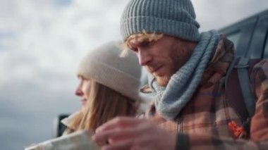 Arabanın yakınındaki haritaya bakan turist çiftin yakın görüntüsü.