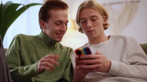 Blond Gay Paar Kijken Naar Telefoon Praten Huis — Stockvideo