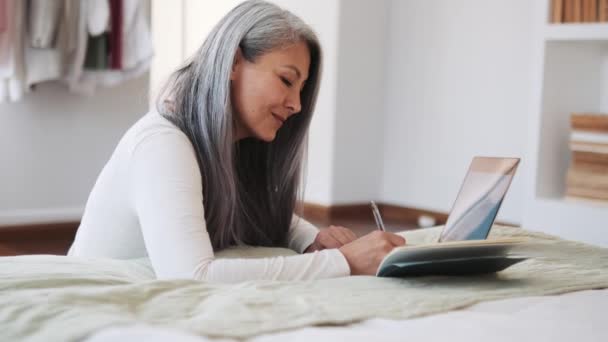 Positive Asian Woman Working Laptop Writing Notepad Home — Stock Video