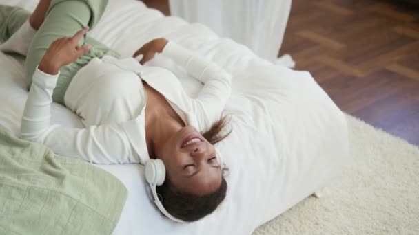 Positive African Woman Listening Music Headphones Bed — Stock Video