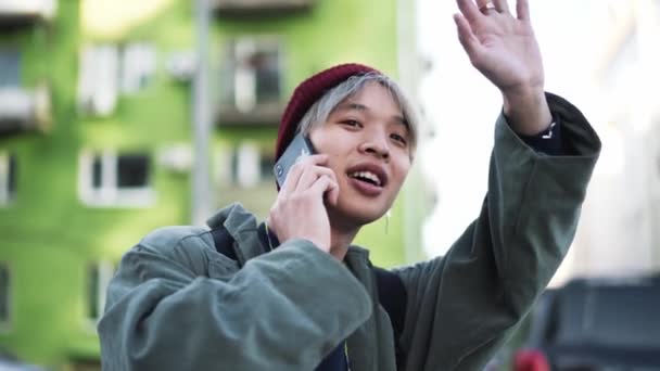 Koreanska Killen Pratar Med Sin Vän Telefon Och Vinkar Till — Stockvideo