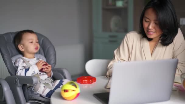 Mutlu Asyalı Anne Tablosu Oğlu Mutfakta Parmağıyla Işaret Ederken — Stok video