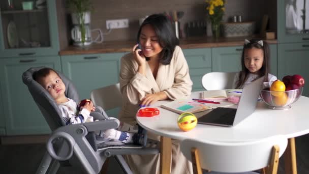 Χαμογελώντας Ασιατική Μαμά Μιλώντας Στο Τηλέφωνο Ενώ Κάθεται Παιδιά Της — Αρχείο Βίντεο