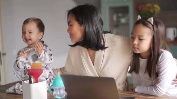 Handsome Asian Mom Daughter Looking Laptop While Her Baby Playing — Stock Video