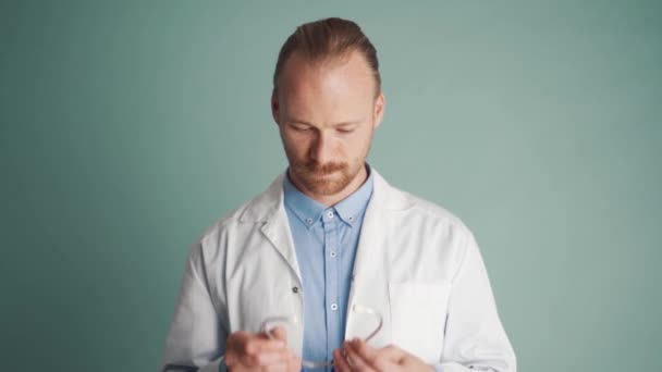 Serious Doctor Wearing Stethoscope Blue Studio — Stock Video
