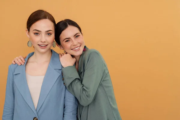 Young Two Women Wearing Jackets Hugging Smiling Camera Isolated Yellow — Stock Photo, Image