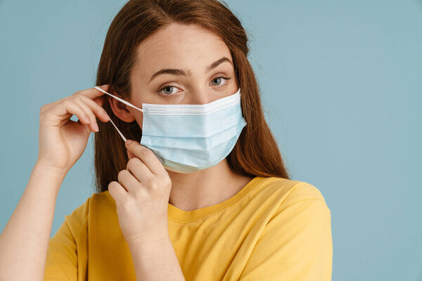 Young Ginger Woman Face Mask Posing Looking Camera Isolated Blue — Stock Photo, Image