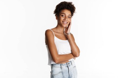 Young black woman in tank top smiling and looking at camera isolated over white background