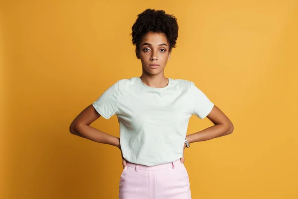 Young Black Woman Shirt Posing Looking Camera Isolated Yellow Background — Stok fotoğraf