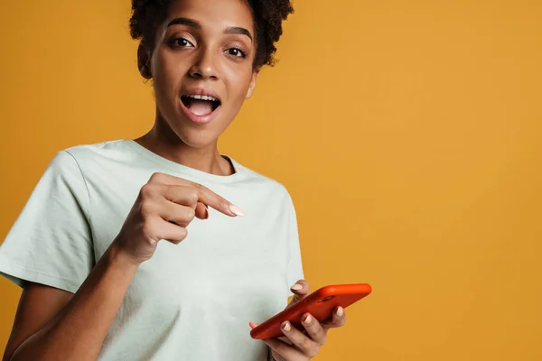 Young Black Woman Using Pointing Finger Mobile Phone Isolated Yellow — Fotografia de Stock