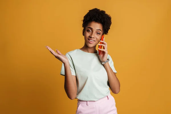 Young Black Woman Holding Copyspace While Talking Cellphone Isolated Yellow — Fotografia de Stock