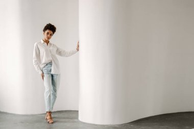 Young black woman standing and looking at camera indoors