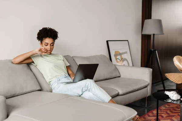 Young Black Woman Working Laptop While Sitting Couch Home — Stockfoto