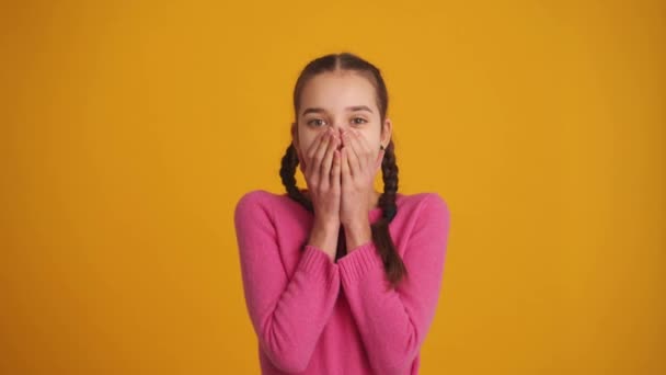 Surprised Girl Pigtails Covering Her Mouth Yellow Studio — 图库视频影像