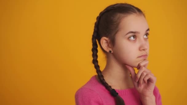Meditative Girl Pigtails Thinking Yellow Studio — Vídeo de Stock