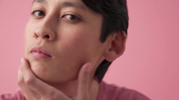 Asian Man Correcting His Appearance Camera Pink Studio — Stock video