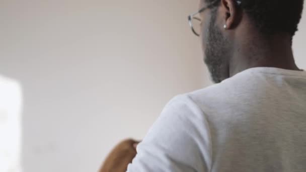 Rear View African Man Packing His Things Home — Video Stock