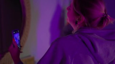 Happy woman making selfie by phone at home