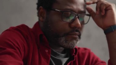 Handsome African man reading something in office