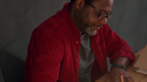 Positive African Man Writing Something Notepad Office Night — Video Stock