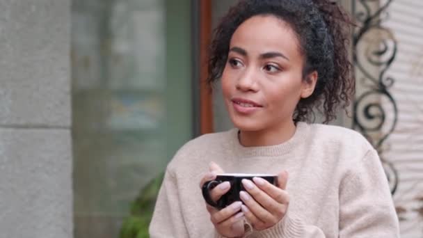 Pensive African Woman Drinking Coffee Outdoors — Stock videók