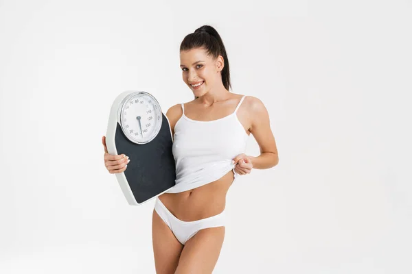 European Woman Wearing Underwear Smiling While Holding Bathroom Scales Isolated — Stock Fotó