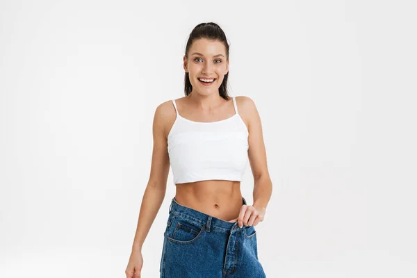 European Brunette Woman Smiling While Posing Big Jeans Isolated White — Fotografia de Stock