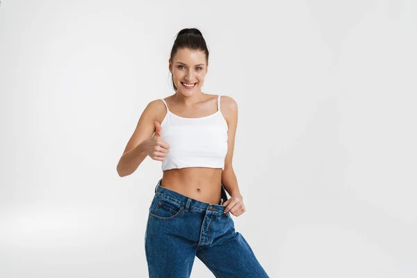 European Brunette Woman Gesturing While Posing Big Jeans Isolated White — Fotografia de Stock