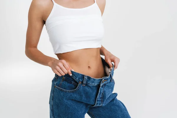 European Woman Showing Her Waist While Posing Big Jeans Isolated — Fotografia de Stock